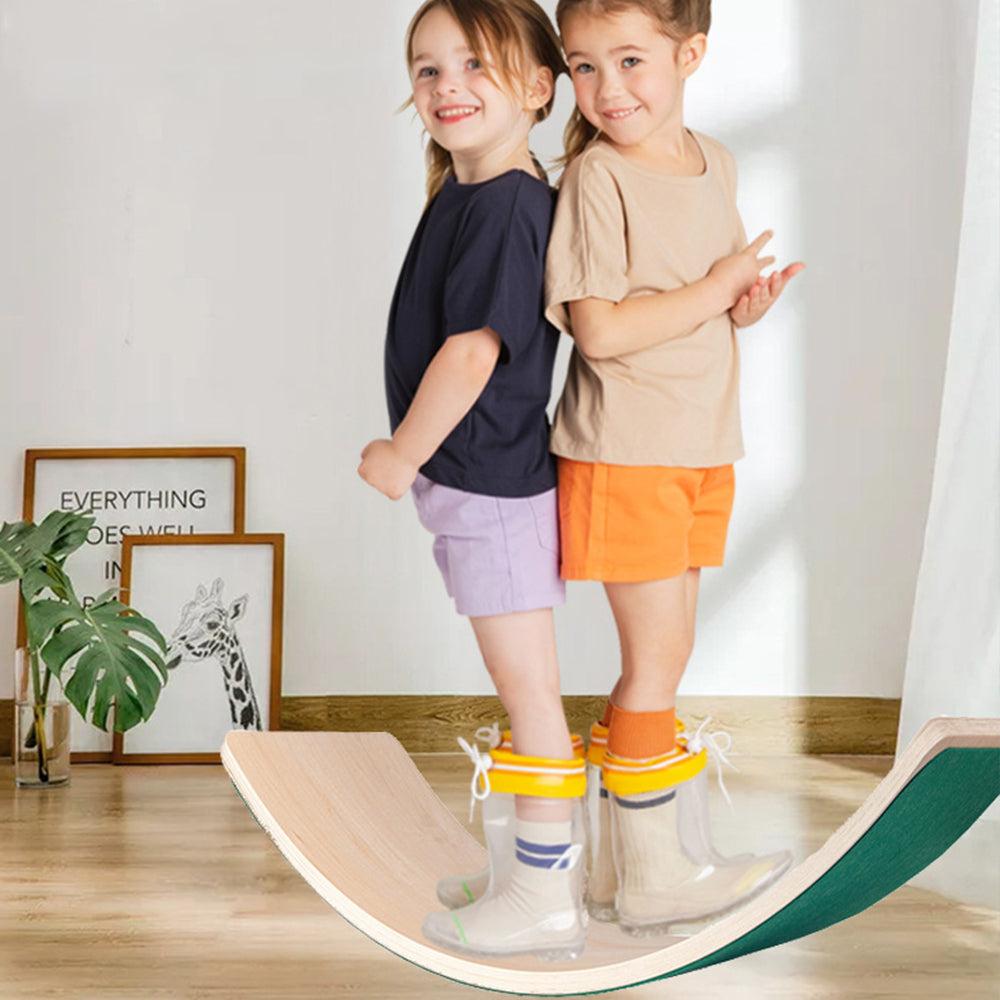 Kinder stehen und balancieren auf gebogenen Holz-Wackelbrettern für sensorisches Spiel.