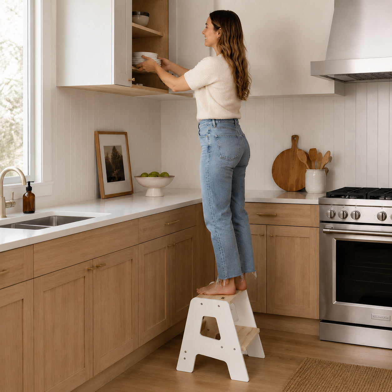 Adult using a sturdy wooden step stool in the kitchen