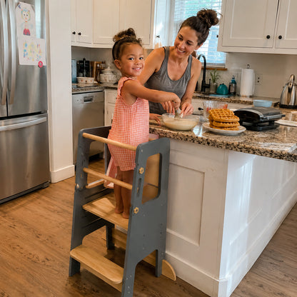 Wooden learning tower designed for toddlers to explore everyday activities independently