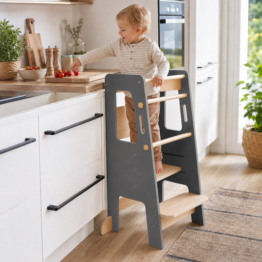 Montessori learning tower helping toddlers safely reach the kitchen counter